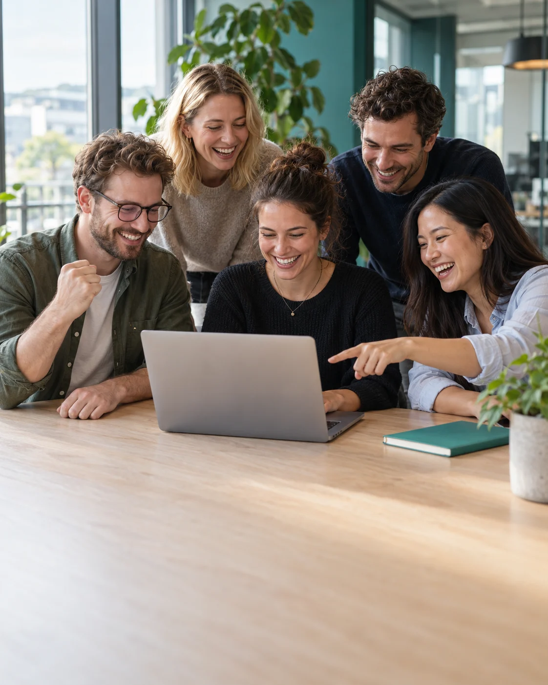 The team celebrating the platform launch around a laptop